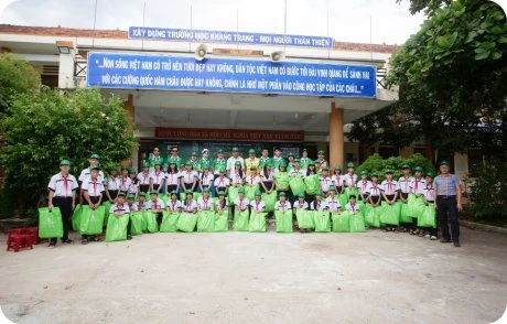 Students lining up to receive gifts at a charity program